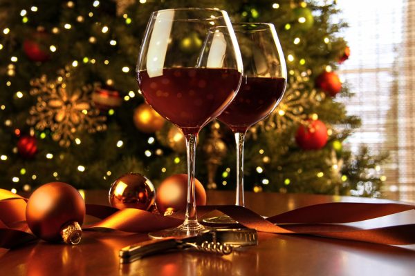 red-wine -on-a-table-wtih-christmas-tree